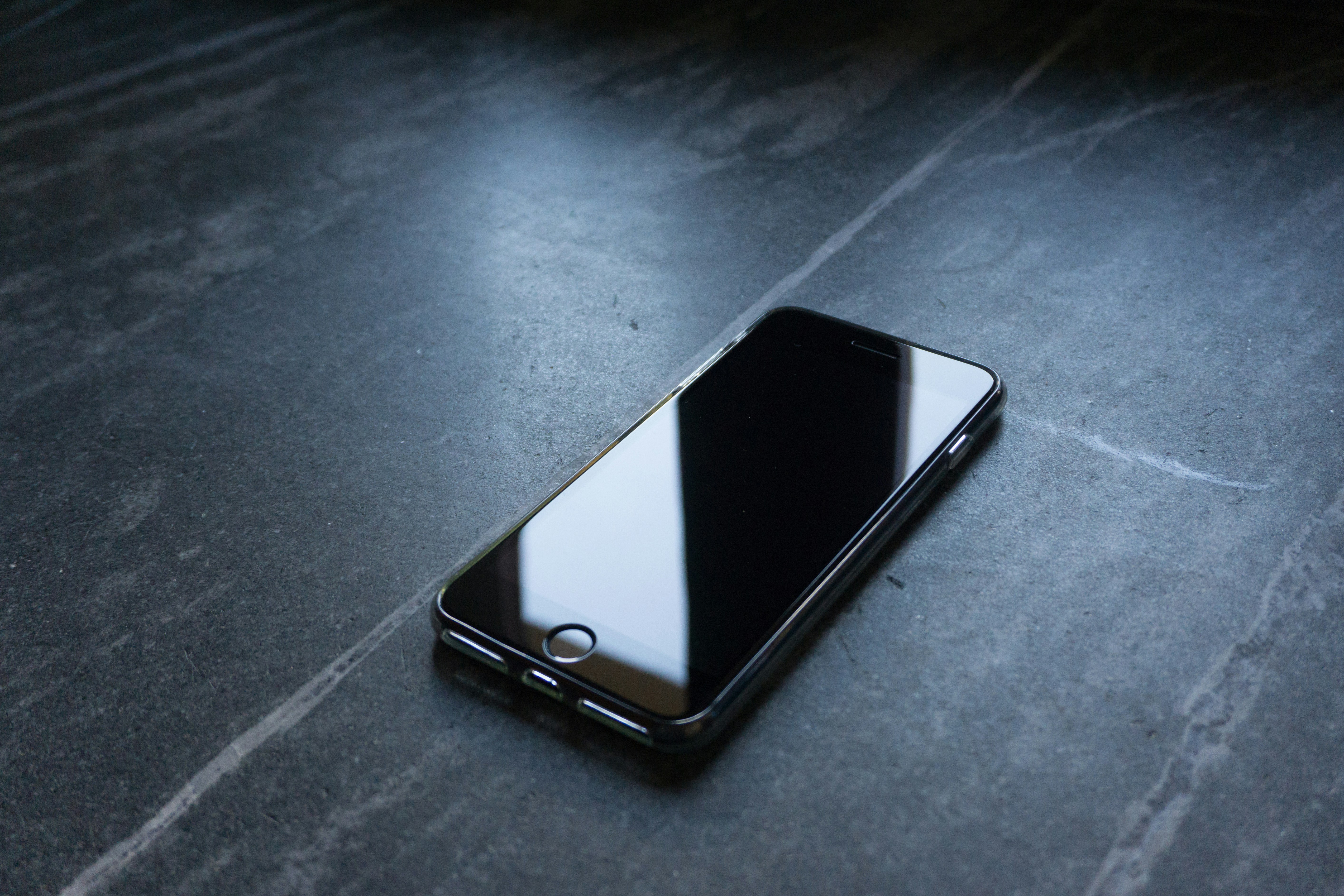 Black phone on empty table.